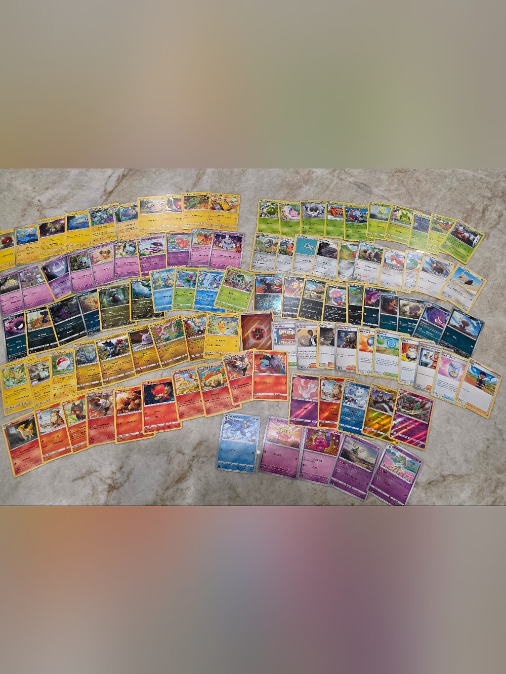 100 Pokémon cards, including Holos, Rares, and Japanese edition